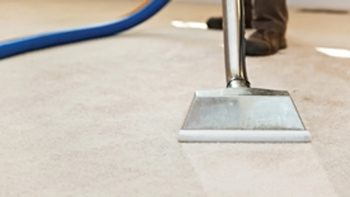 Carpet cleaning wand head gliding over a light carpet during hot-water extraction, Wilmington, NC.